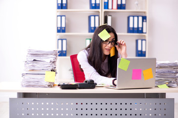 Young female employee in conflicting priorities concept 