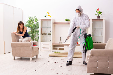 Young professional contractor doing pest control at flat 
