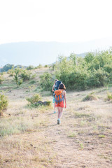 Two women are traveling through the mountains.