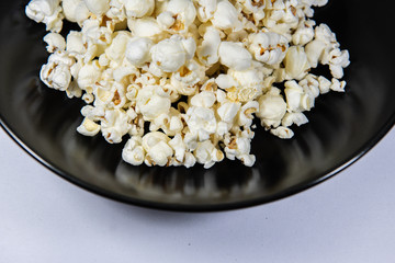 Popcorn in a plate on white background