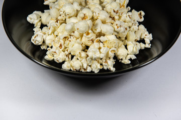 Popcorn in a plate on white background