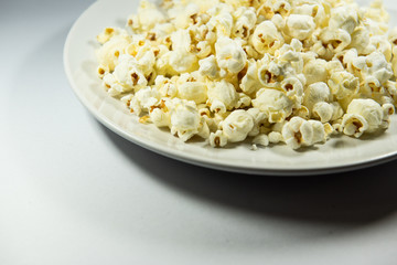 Popcorn in a plate on white background
