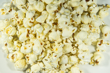 Popcorn in a plate on white background