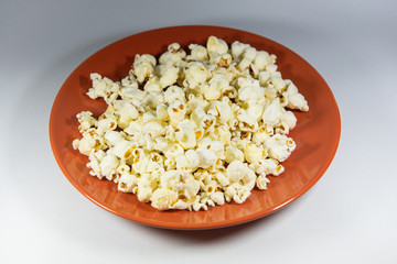 Popcorn in a plate on white background