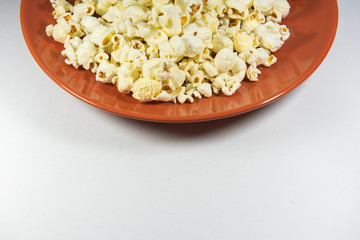 Popcorn in a plate on white background