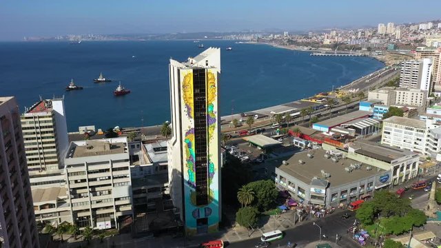 Aerial drone view of Iglesia de los Doce Apostoles old church and colourfully decorated houses on the hills of the historic port city of Valparaiso, Chile