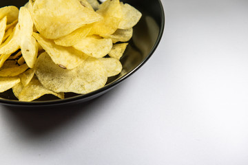 Potato chips in a plate on white background