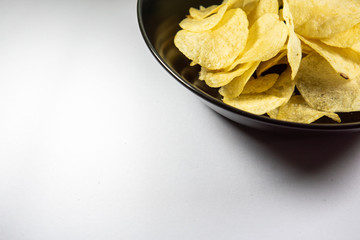 Potato chips in a plate on white background