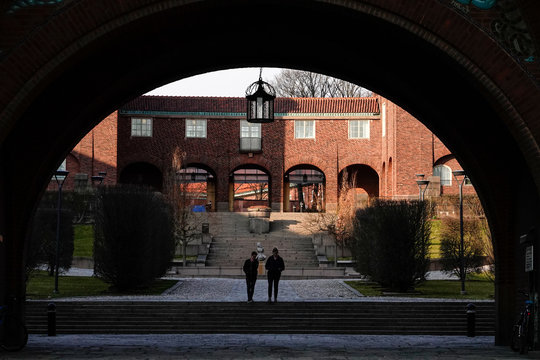 Stockholm, Sweden Two people walking under a classic archway on the campus of the Royal Institute of Technology, or KTH.