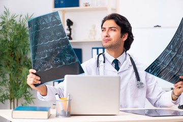 Young handsome doctor radiologist working in the clinic 