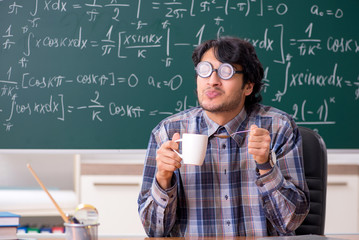 Funny male math teacher in the classroom 