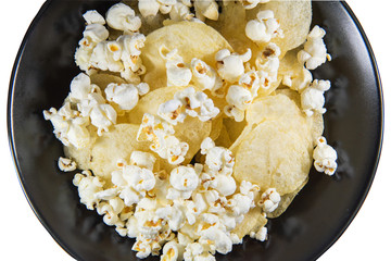 Popcorn and Potato chips in a plate on isolated background