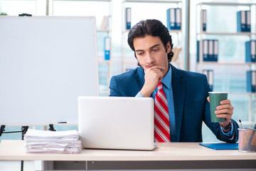 Young handsome businessman in front of whiteboard 