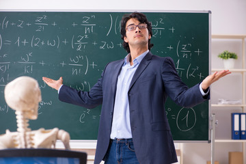 Young male math teacher and student skeleton 
