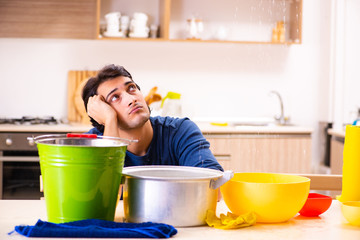 Young man in water leakage from the neighbors concept 