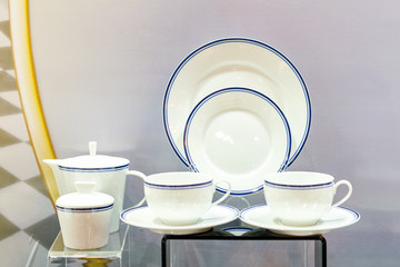 various new kitchenware such as teapot cup plate etc on table