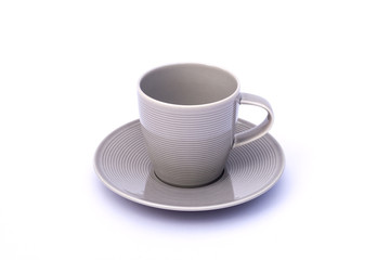 Empty gray cup of coffee with plate isolated on white background.