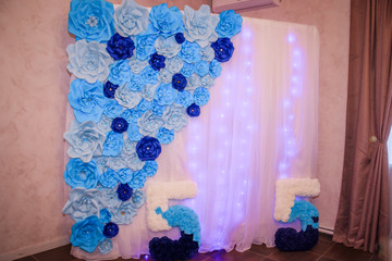Decorations of blue paper flowers. Paper flowers . Handwork.