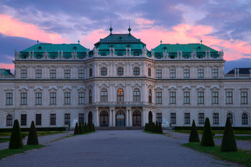 Fototapeta na wymiar Facade of the Belvedere Palace against the backdrop of the April sunset. Vienna, Austria