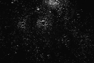 Air bubbles in the water background.Abstract oxygen bubbles in the sea.Water bubbles isolate on black background.Black and white tone style.