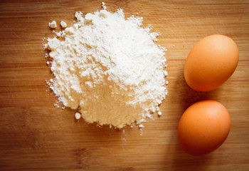 eggs and flour on a wooden board