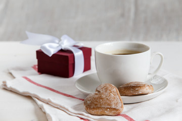 The gift and cup of coffe with cookies
