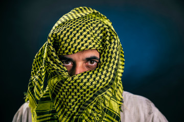 Eastern appearance a man in a traditional national Arab dress covered his face with a handkerchief,...
