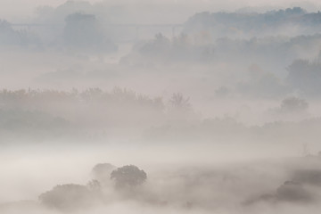 Autumn landscape with fog in valley