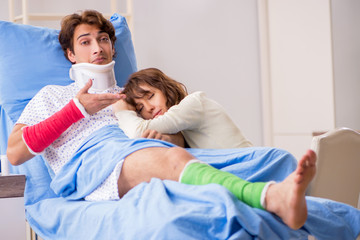 Fototapeta premium Loving wife looking after injured husband in hospital 