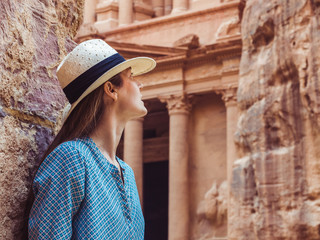 Fashionable woman, exploring the sights of the ancient, fabulous city of Petra in Jordan. Colorful...