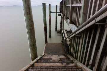 Coastal pier steps on cloudy day