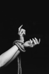 tied hands on black background