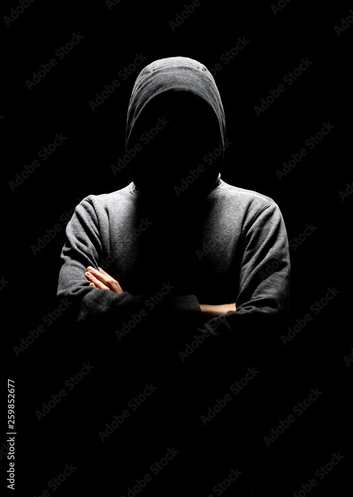 Wall mural Computer hacker in white mask and hoodie. Obscured dark face. Data thief, internet fraud, darknet and cyber security concept.