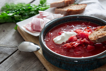 Ukrainian and russian national red soup borsch. Beetroot soup on wooden background