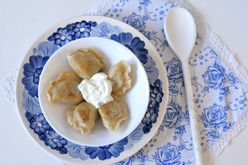 Dumplings pierogi with sour cream