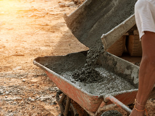 industrial construction labor work concrete mix with cart