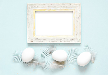 Frame with easter eggs and feathers. Happy Easter concept.