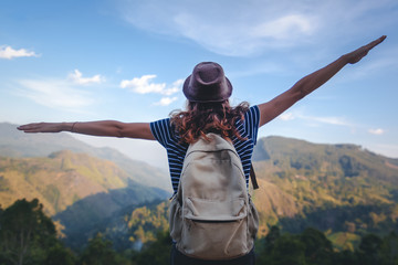 Young beautiful woman traveler enjoys mountain, beautiful landscape and active lifestyle. Sri Lanka - Ceylon Island