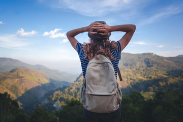 Young beautiful woman traveler enjoys mountain, beautiful landscape and active lifestyle. Sri Lanka - Ceylon Island