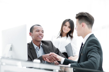 handshake of business partners sitting at a table Desk