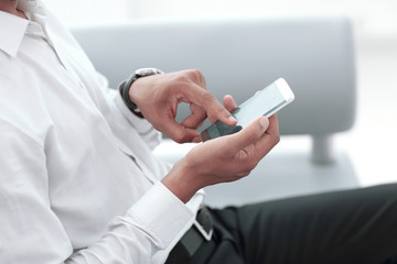 Obraz na płótnie Canvas close up. modern man typing on his smartphone.