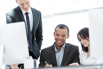 project Manager and business team discussing work documents