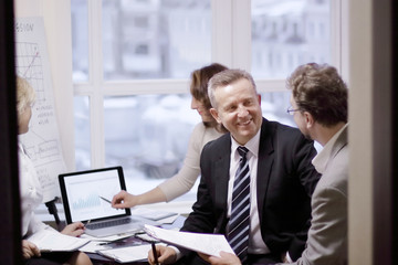 business partners engaged in dialogue in a modern office.