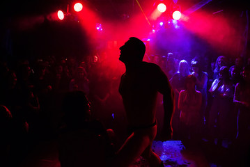 silhouette of a male stripper performing on stage