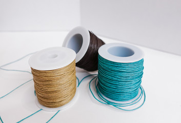 Bobbins of thread on white background