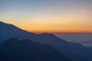 Majestic sunset in the mountains landscape with sunny beams. Dramatic scene. Sri Lanka Ella