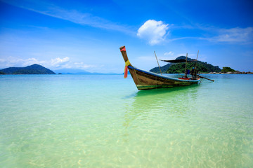 Fototapeta na wymiar Boat in beautiful sea beach with bright blue sky at Ranong ,Thailand