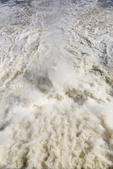 Top view of the waterfall. Above the view of the reservoir from a large dam. Discharge of water from the reservoir, the autumn drift on the river. Hydroelectric power station on the river