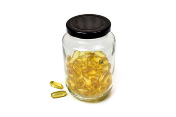 Close up of gold fish oil capsules isolated on white background. Omega 3 with Vitamin E. Salmon fish capsules. Drug. Supplementary food background view.