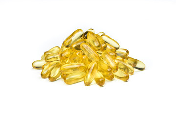 Close up to Golden Pile of salmon fish oil capsules isolated on white background. Supplementary food for good health. Omega 3. Vitamin E. Salmon fish capsules view.